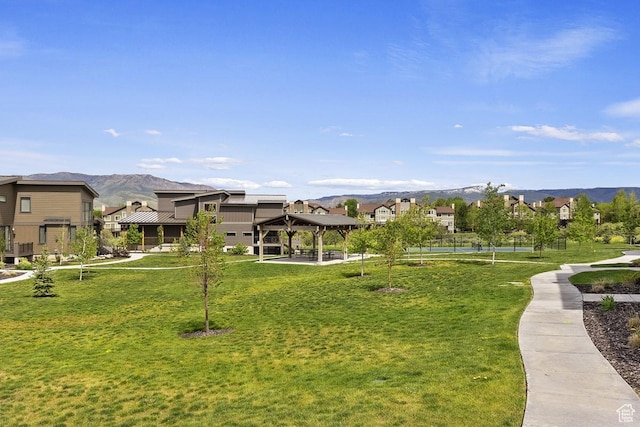 view of home's community featuring a mountain view, a gazebo, a residential view, and a lawn