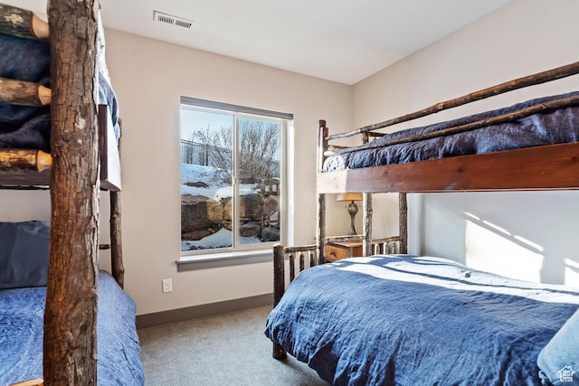 bedroom featuring carpet flooring, baseboards, and visible vents