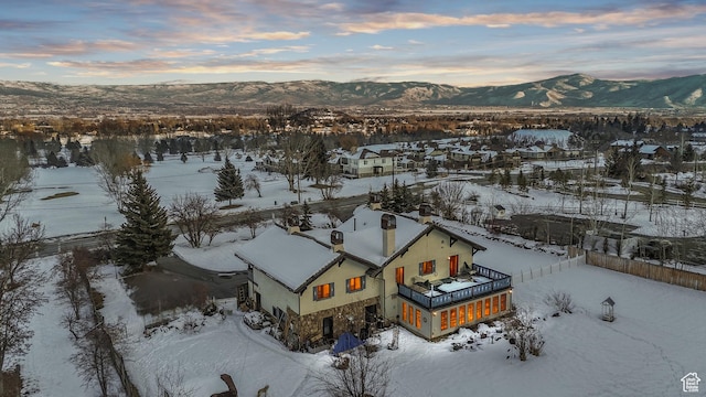 snowy aerial view with a mountain view