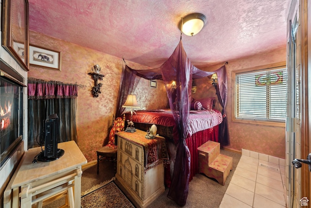 bedroom featuring a textured ceiling and light tile patterned floors