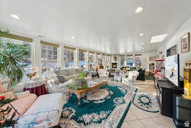 tiled living room with a skylight