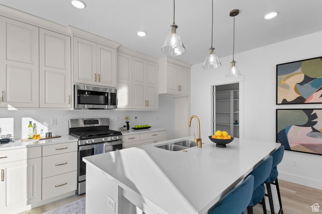 473 N Haven Dr Unit 256, Mapleton, UT 84664 - kitchen featuring white cabinetry, appliances with stainless steel finishes, a center island with sink, and sink