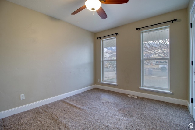 spare room featuring ceiling fan and carpet flooring