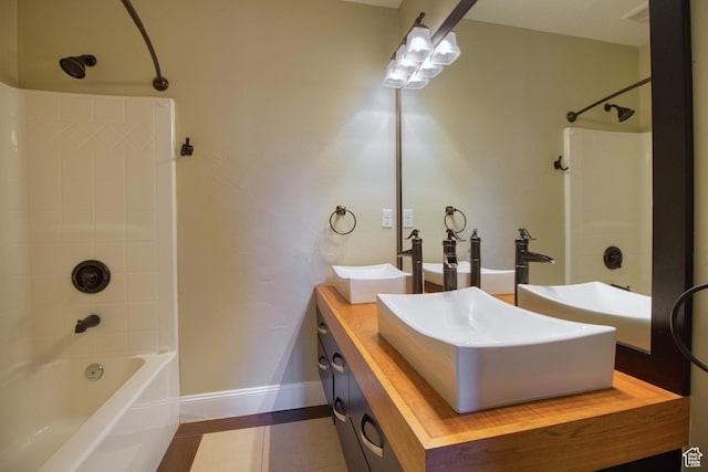 bathroom featuring bathtub / shower combination, vanity, and tile patterned flooring