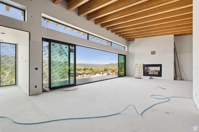 5220 N Old Ranch Rd, Park City, UT 84098 - unfurnished living room featuring a fireplace and beamed ceiling