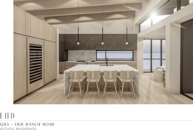 5220 N Old Ranch Rd, Park City, UT 84098 - kitchen featuring modern cabinets, beamed ceiling, light wood finished floors, light brown cabinetry, and a kitchen bar