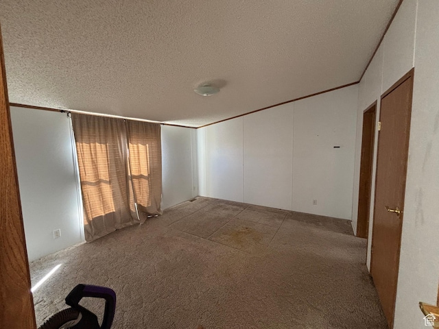 unfurnished room with light carpet and a textured ceiling