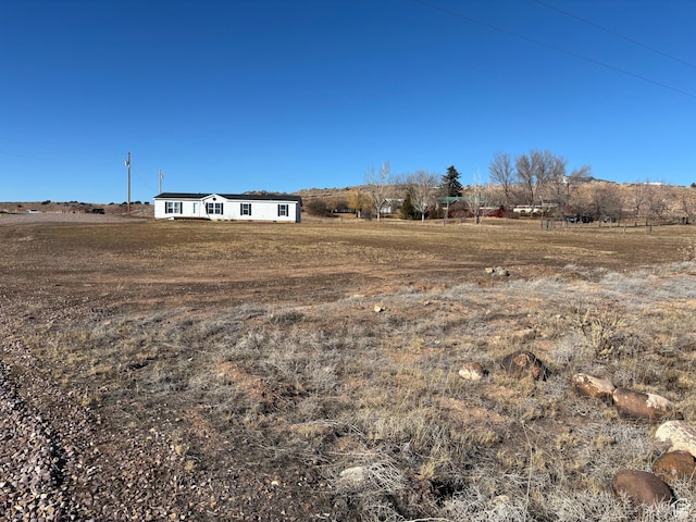 view of yard with a rural view