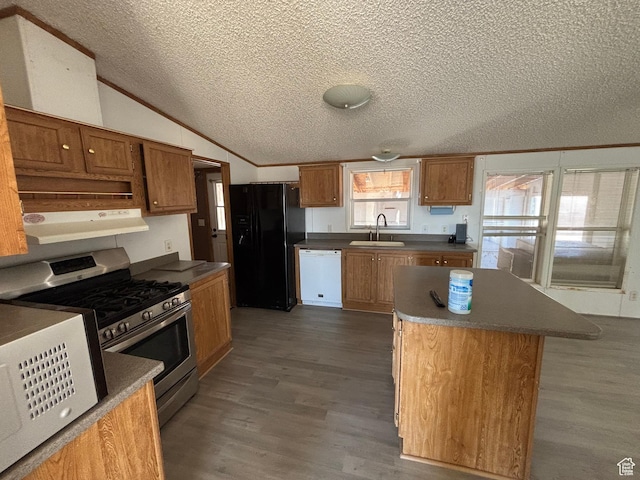 kitchen with lofted ceiling, a center island, sink, white appliances, and dark hardwood / wood-style flooring