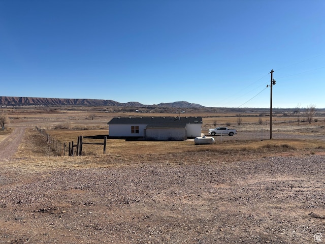exterior space with a rural view and a mountain view