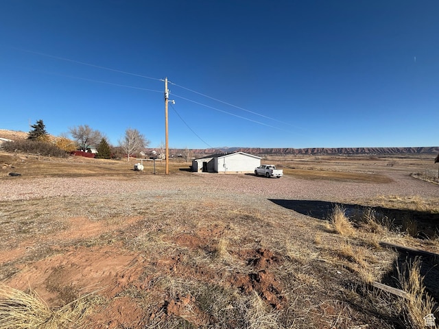 view of yard with a rural view