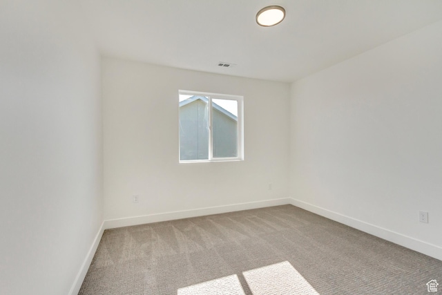 carpeted empty room with baseboards and visible vents