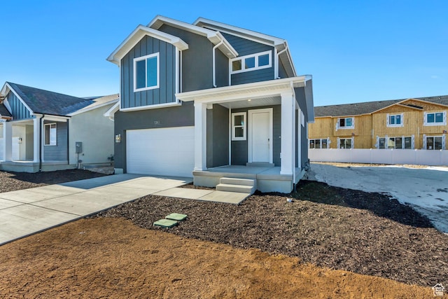view of front of house featuring concrete driveway, board and batten siding, covered porch, an attached garage, and stucco siding