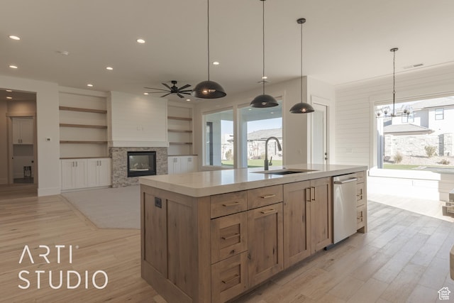 3783 S Kennedy Ln, Washington, UT 84780 - kitchen with an island with sink, ceiling fan, a multi sided fireplace, stainless steel dishwasher, and sink