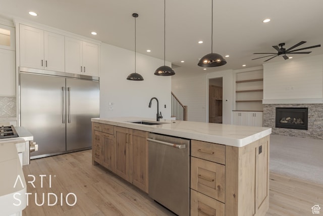3783 S Kennedy Ln, Washington, UT 84780 - kitchen with sink, hanging light fixtures, a kitchen island with sink, appliances with stainless steel finishes, and white cabinets