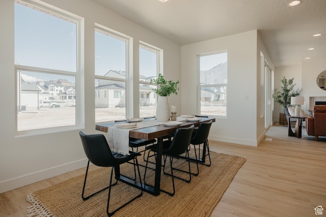 dining space featuring baseboards, recessed lighting, and light wood-style floors