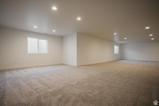 interior space with light carpet, baseboards, and recessed lighting