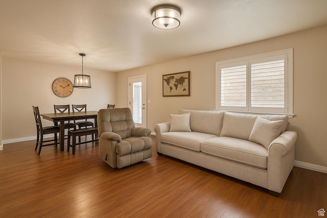 1841 E Whitetail Dr, Layton, UT 84040 - living area with wood finished floors, baseboards, plenty of natural light, and a chandelier