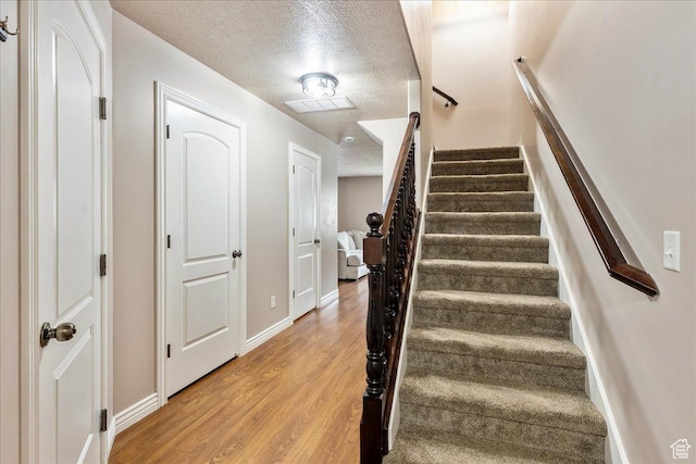 1841 E Whitetail Dr, Layton, UT 84040 - staircase featuring a textured ceiling and wood finished floors