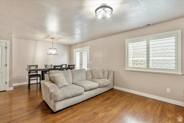 1841 E Whitetail Dr, Layton, UT 84040 - living area featuring a textured ceiling and wood finished floors