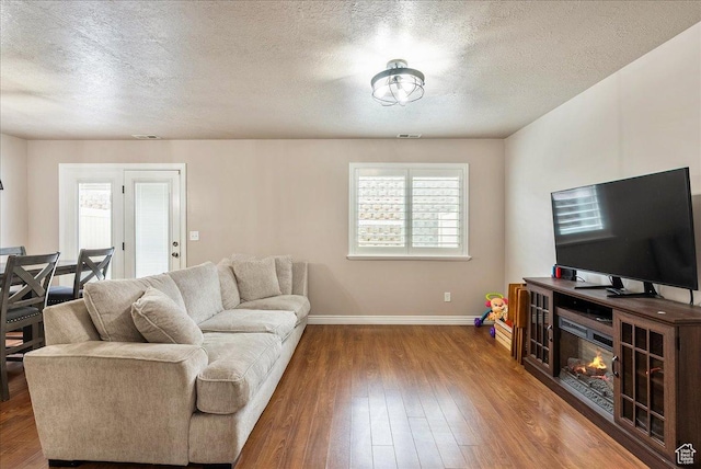 1841 E Whitetail Dr, Layton, UT 84040 - living room featuring a textured ceiling and hardwood / wood-style flooring