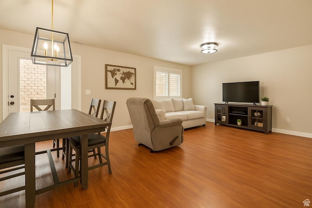 1841 E Whitetail Dr, Layton, UT 84040 - living area featuring wood finished floors, a chandelier, and baseboards