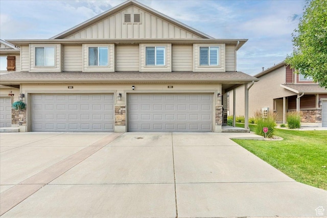 1841 E Whitetail Dr, Layton, UT 84040 - view of property featuring board and batten siding, a garage, concrete driveway, and stone siding