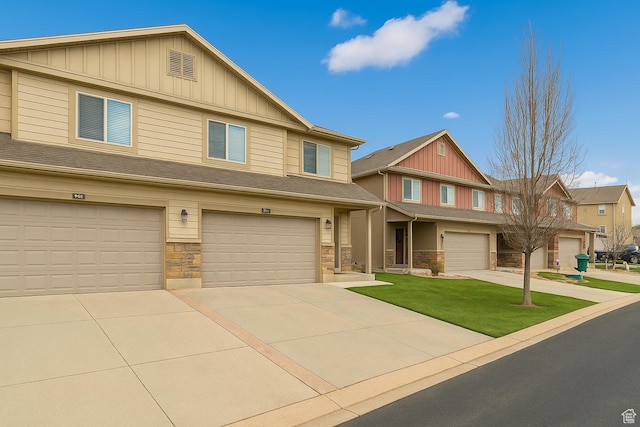 1841 E Whitetail Dr, Layton, UT 84040 - view of front of property featuring board and batten siding, stone siding, driveway, and an attached garage