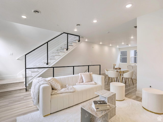 living room with recessed lighting, stairway, visible vents, and baseboards