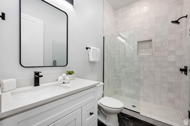 bathroom with toilet, a shower, tile patterned flooring, and vanity