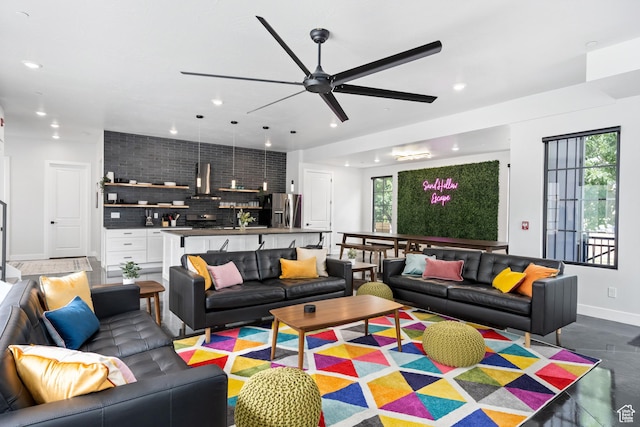 living room with ceiling fan and a healthy amount of sunlight