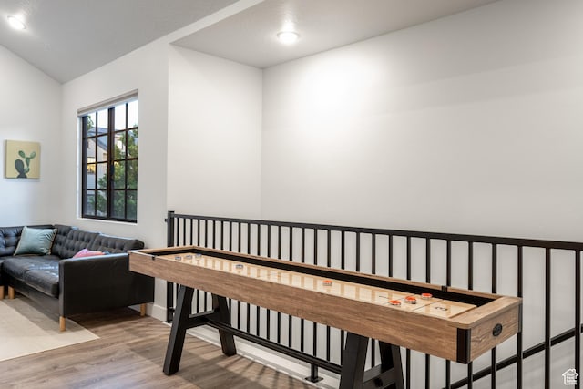 interior space with vaulted ceiling and hardwood / wood-style flooring