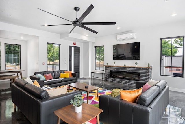living room featuring ceiling fan, a wall mounted AC, a fireplace, and plenty of natural light