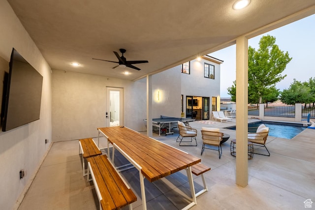 view of patio with ceiling fan and a fenced in pool