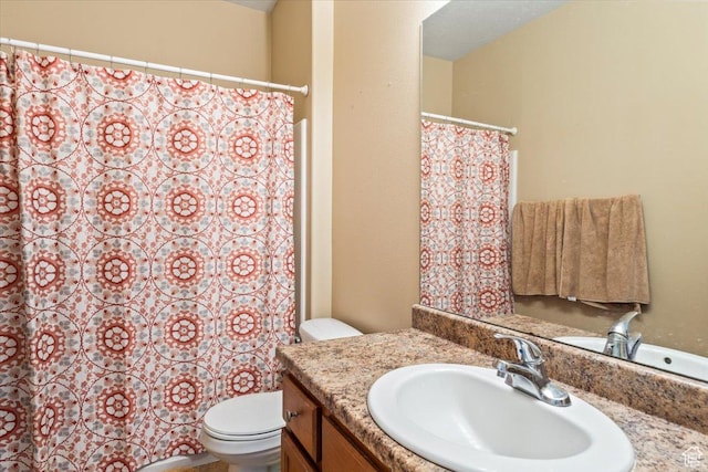 bathroom featuring toilet and vanity