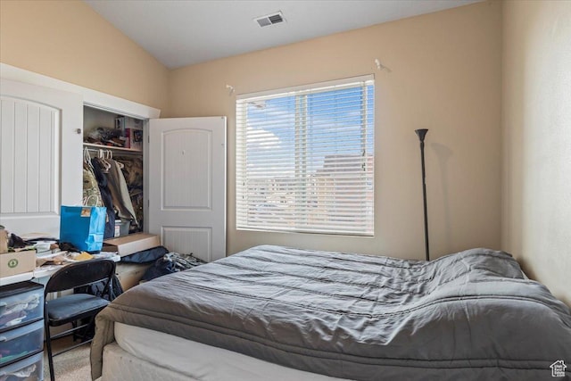 bedroom with lofted ceiling and a closet