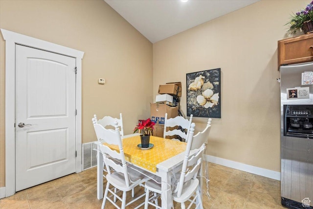 dining space featuring lofted ceiling
