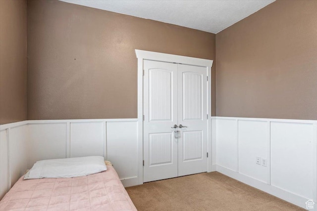 bedroom with light colored carpet