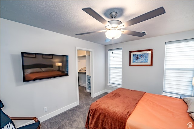 1283 N Gallen Rd W, Santa Clara, UT 84765 - carpeted bedroom featuring ceiling fan, a textured ceiling, a closet, and a walk in closet