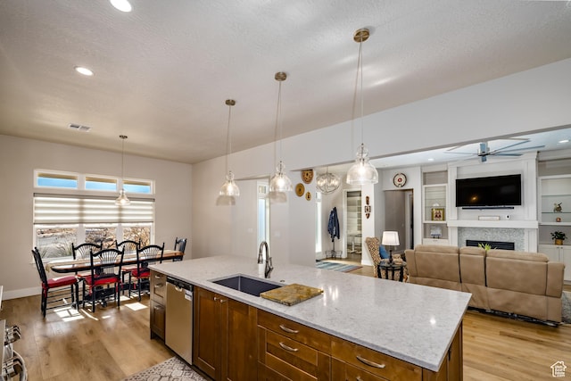 1283 N Gallen Rd W, Santa Clara, UT 84765 - kitchen with decorative light fixtures, sink, stainless steel dishwasher, and an island with sink