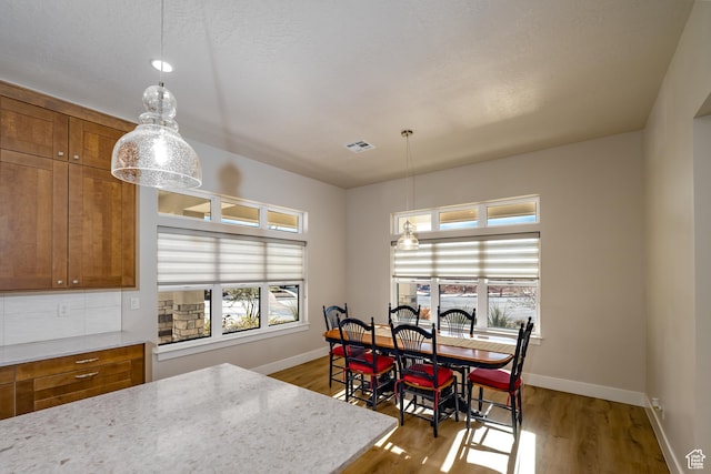 1283 N Gallen Rd W, Santa Clara, UT 84765 - dining space featuring dark wood-type flooring, a wealth of natural light, and a textured ceiling
