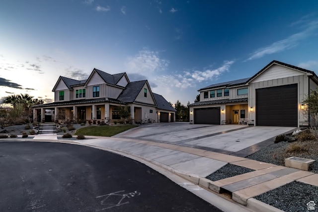 1283 N Gallen Rd W, Santa Clara, UT 84765 - view of front of house featuring solar panels, covered porch, and a garage