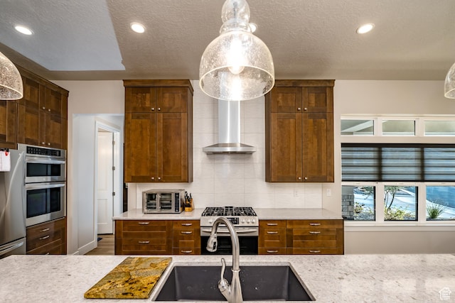 1283 N Gallen Rd W, Santa Clara, UT 84765 - kitchen with stainless steel appliances, decorative light fixtures, a textured ceiling, wall chimney exhaust hood, and sink