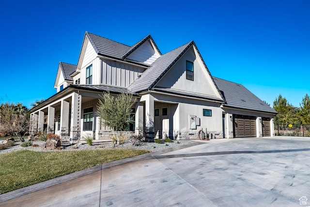 1283 N Gallen Rd W, Santa Clara, UT 84765 - view of front of house featuring covered porch, a garage, and a front lawn