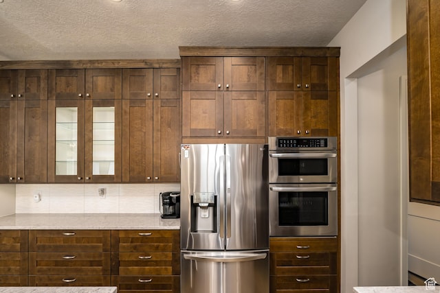 1283 N Gallen Rd W, Santa Clara, UT 84765 - kitchen with light stone countertops, a textured ceiling, and appliances with stainless steel finishes