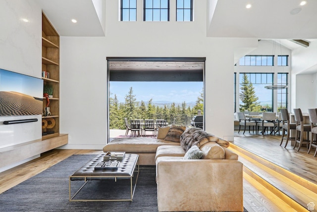 7242 Lupine Dr, Park City, UT 84098 - living room with wood finished floors, a towering ceiling, built in features, and recessed lighting