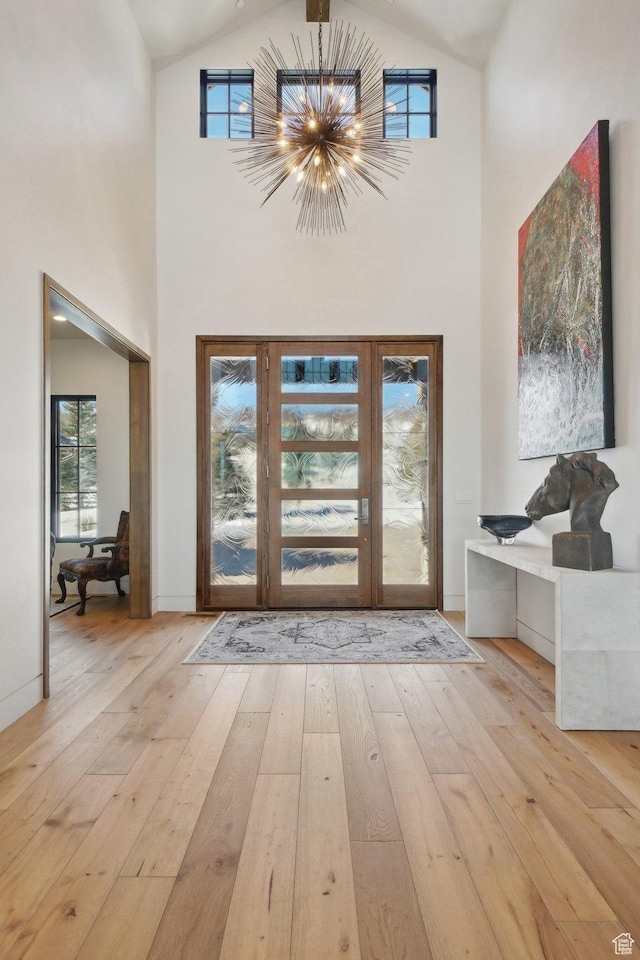 7242 Lupine Dr, Park City, UT 84098 - foyer entrance with light wood-style flooring, high vaulted ceiling, and a chandelier