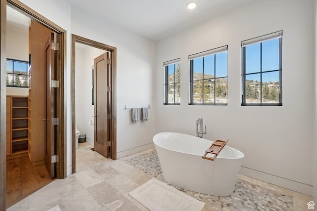 7242 Lupine Dr, Park City, UT 84098 - bathroom featuring a soaking tub, healthy amount of natural light, toilet, and recessed lighting