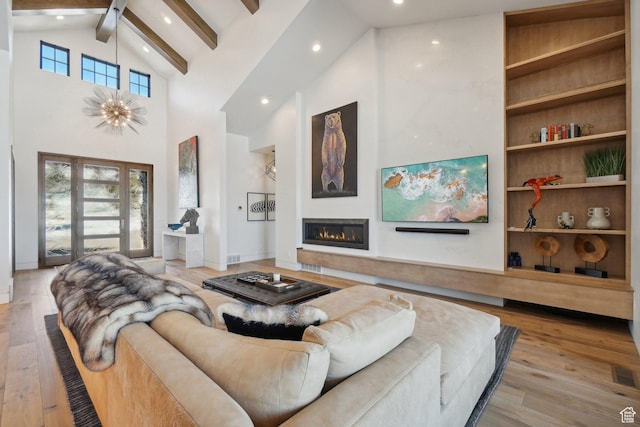 7242 Lupine Dr, Park City, UT 84098 - living area with high vaulted ceiling, recessed lighting, beam ceiling, wood-type flooring, and a glass covered fireplace