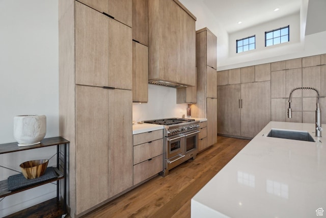 7242 Lupine Dr, Park City, UT 84098 - kitchen featuring range with two ovens, a sink, light brown cabinets, modern cabinets, and light countertops